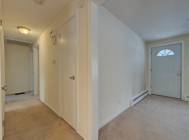 entrance foyer with light carpet, baseboard heating, and visible vents