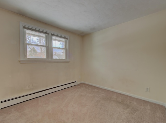 empty room with baseboards, a baseboard heating unit, and light colored carpet