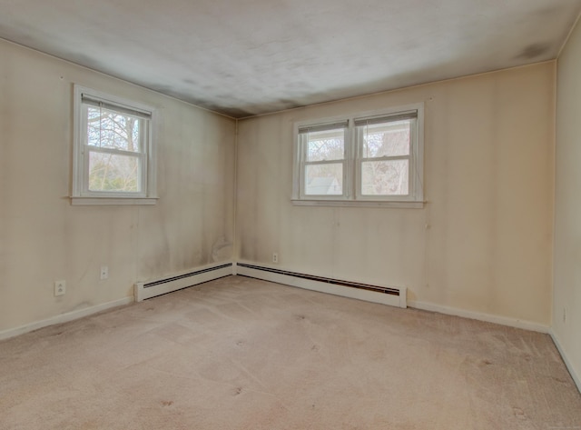 carpeted empty room featuring baseboards