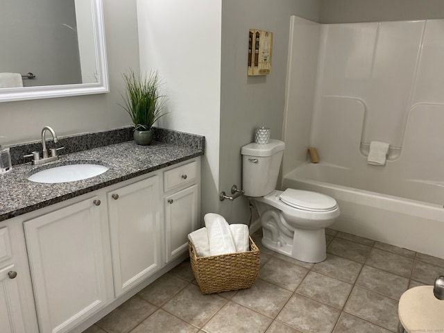 full bathroom with washtub / shower combination, vanity, toilet, and tile patterned floors