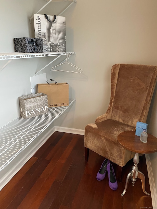 sitting room with baseboards and wood finished floors