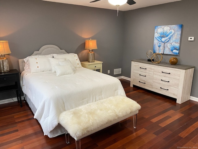 bedroom with dark wood-type flooring, a ceiling fan, visible vents, and baseboards