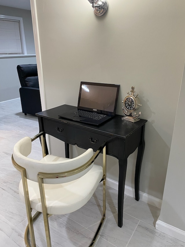 office space featuring marble finish floor and baseboards