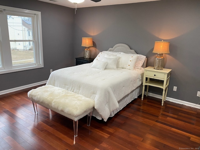 bedroom featuring baseboards and dark wood-type flooring