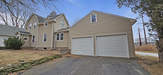 view of front of home with a garage and aphalt driveway