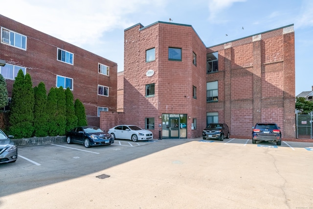 view of building exterior featuring uncovered parking