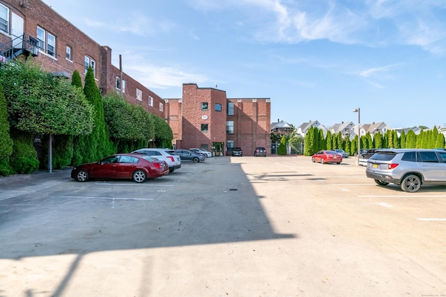 uncovered parking lot featuring a residential view