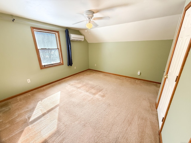 bonus room featuring a ceiling fan, baseboards, a wall mounted AC, vaulted ceiling, and light colored carpet