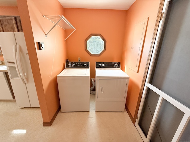 washroom with washer and dryer, laundry area, and baseboards