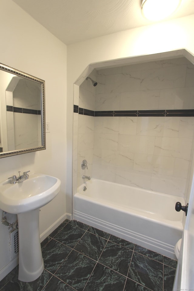 bathroom featuring marble finish floor, shower / bath combination, toilet, and baseboards