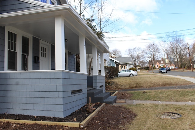 view of side of property featuring a porch