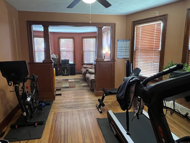 workout area featuring light wood-style floors and a ceiling fan