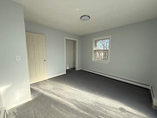 unfurnished bedroom with a textured ceiling, dark carpet, a baseboard radiator, and baseboards