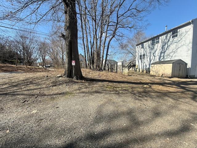 view of yard with a storage shed and an outdoor structure