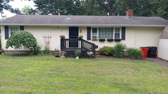 single story home with a chimney, a front lawn, and roof with shingles