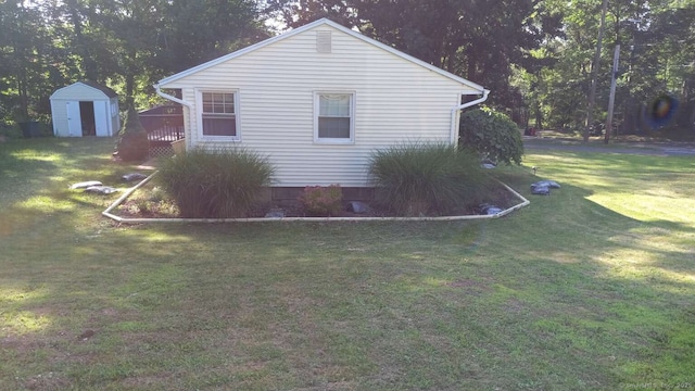 view of property exterior with an outbuilding, a yard, and a shed