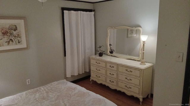 bedroom with dark wood finished floors