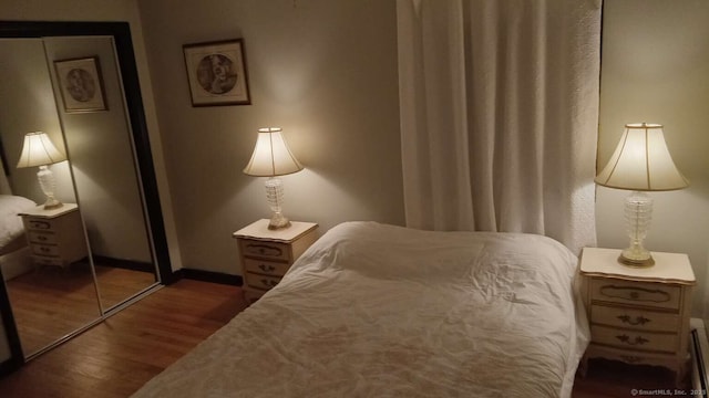 bedroom featuring baseboards and wood finished floors