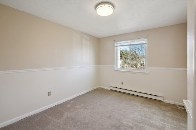 empty room featuring a baseboard heating unit, baseboards, and carpet floors