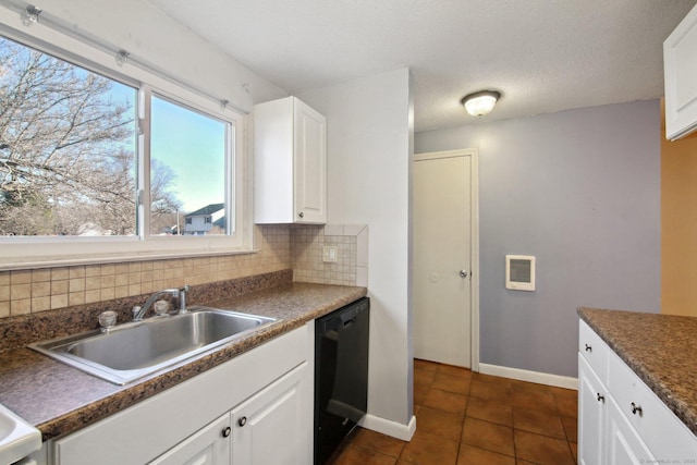 kitchen with a sink, dark countertops, tasteful backsplash, white cabinetry, and dishwasher