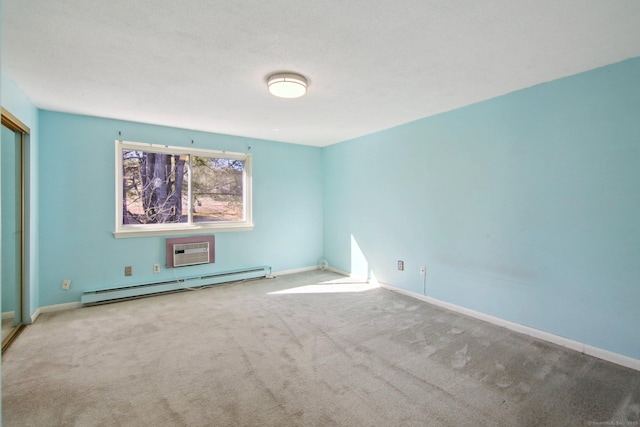 carpeted spare room featuring a wall unit AC, baseboards, and a baseboard radiator