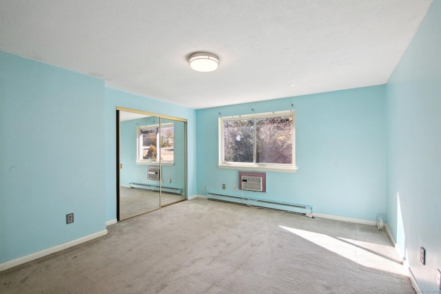 unfurnished bedroom with a baseboard heating unit, baseboards, carpet flooring, a closet, and a baseboard radiator