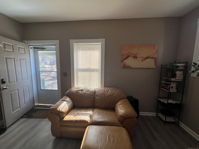 living area with wood finished floors and baseboards