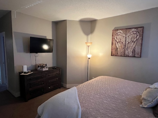 carpeted bedroom featuring a textured ceiling