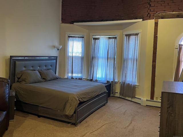 bedroom featuring a baseboard heating unit and carpet flooring