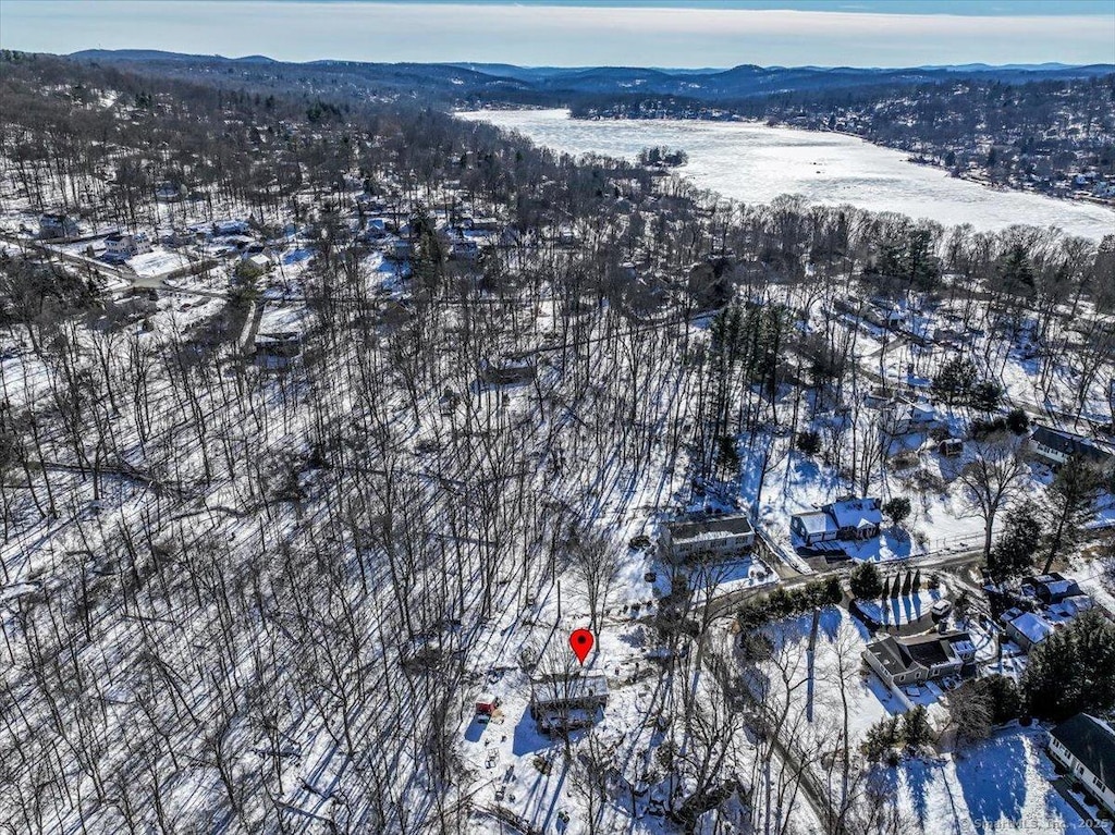 snowy aerial view featuring a mountain view