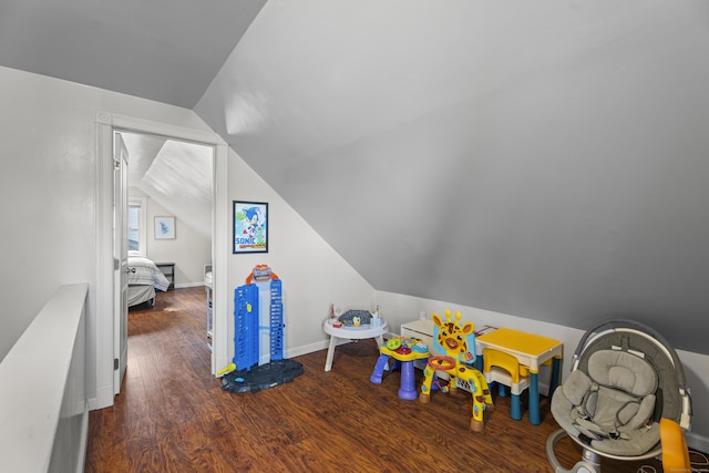 recreation room with vaulted ceiling, baseboards, and wood finished floors