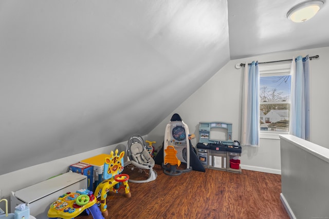 rec room featuring baseboards, lofted ceiling, and wood finished floors