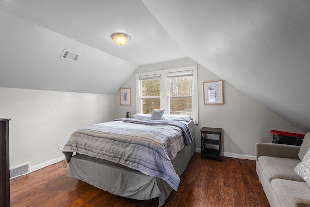 bedroom with wood finished floors, visible vents, and baseboards