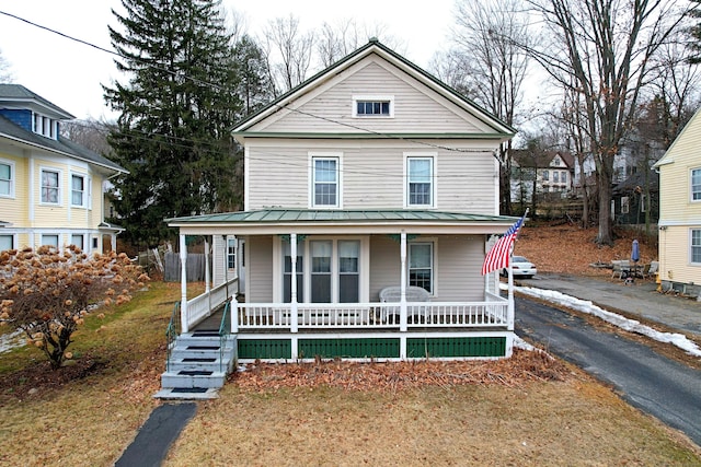 view of front facade with metal roof, a porch, and a standing seam roof