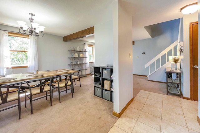 dining area featuring light tile patterned floors, plenty of natural light, light carpet, and stairs