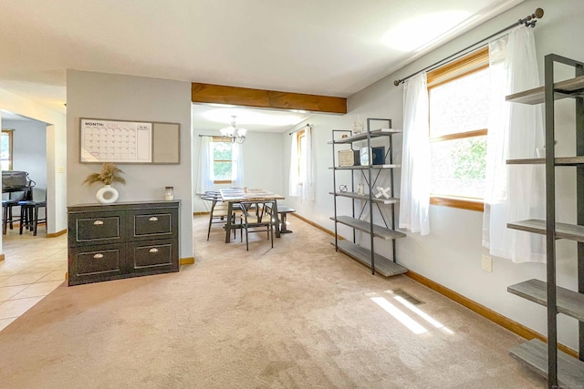 interior space featuring light tile patterned floors, baseboards, visible vents, an inviting chandelier, and light carpet