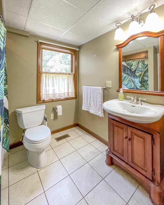 full bathroom featuring visible vents, toilet, tile patterned floors, vanity, and a paneled ceiling