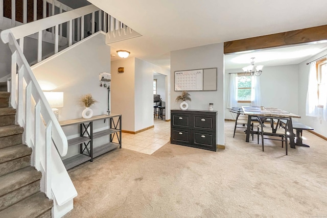 interior space with baseboards, stairs, light carpet, light tile patterned floors, and a notable chandelier