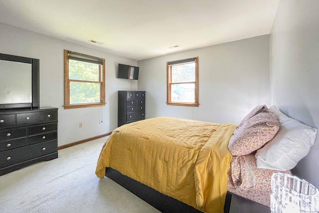 carpeted bedroom with baseboards and visible vents