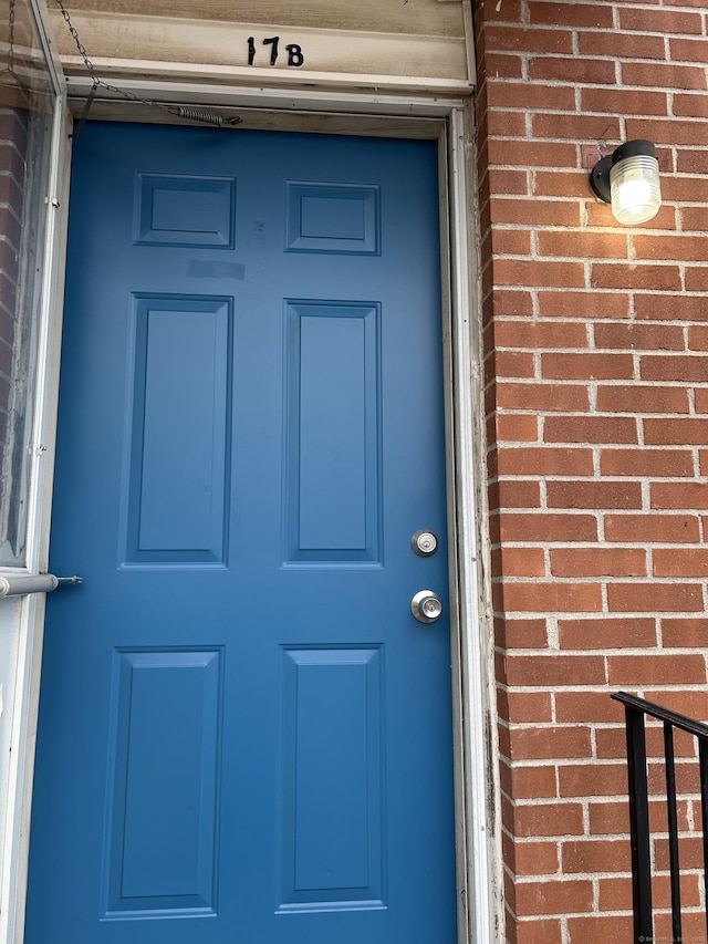 property entrance featuring brick siding