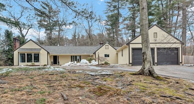 view of front of house with a garage and a chimney