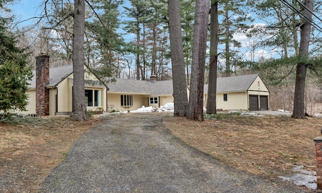 view of front of house with a garage and a chimney