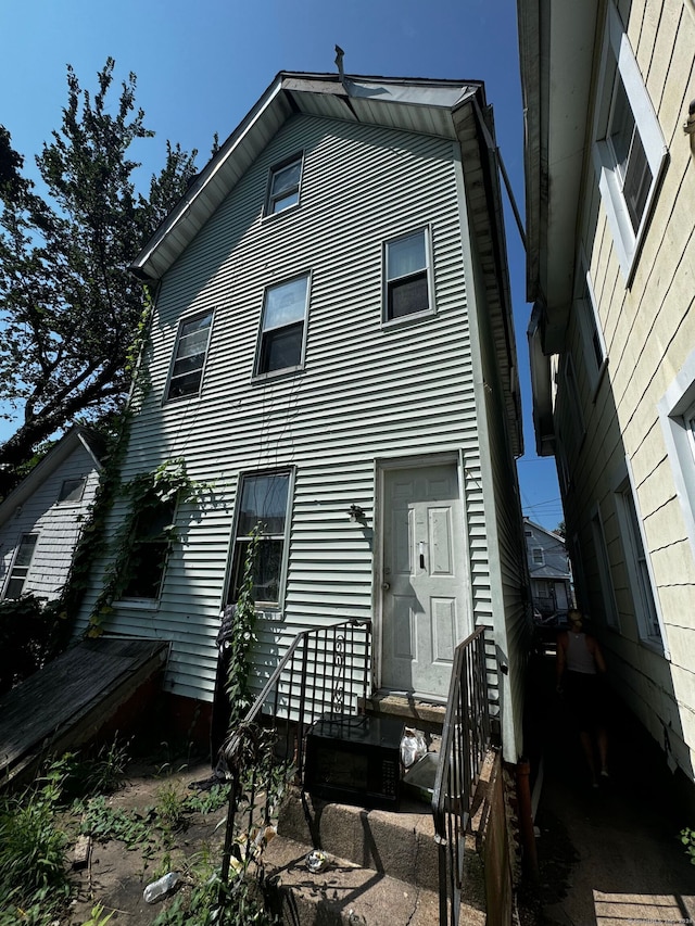 back of property featuring entry steps