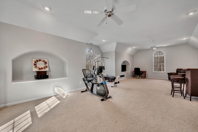 exercise area featuring vaulted ceiling, carpet flooring, and plenty of natural light