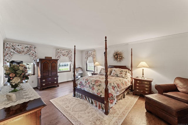 bedroom featuring crown molding and wood finished floors