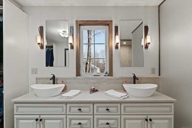 full bathroom featuring double vanity and a sink