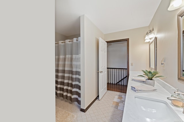 full bath with a sink, baseboards, a shower with curtain, and tile patterned floors