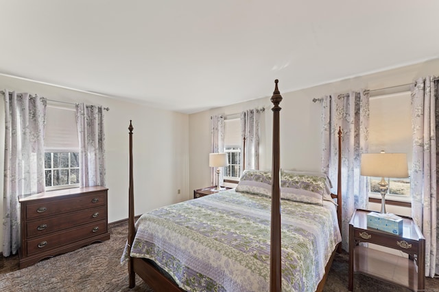 bedroom featuring dark carpet