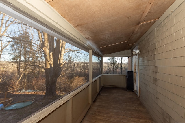 unfurnished sunroom featuring lofted ceiling