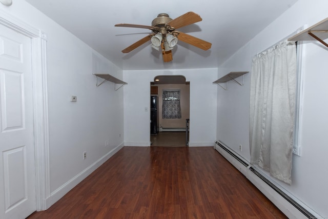 spare room with ceiling fan, wood finished floors, baseboards, and a baseboard radiator